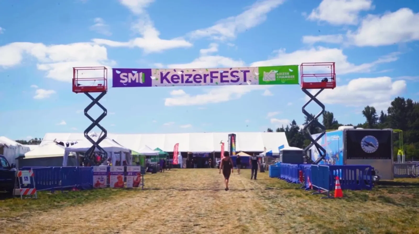 KeizerFEST festival entry arch with sponsor banners over the walkway into Keizer Rapids Park