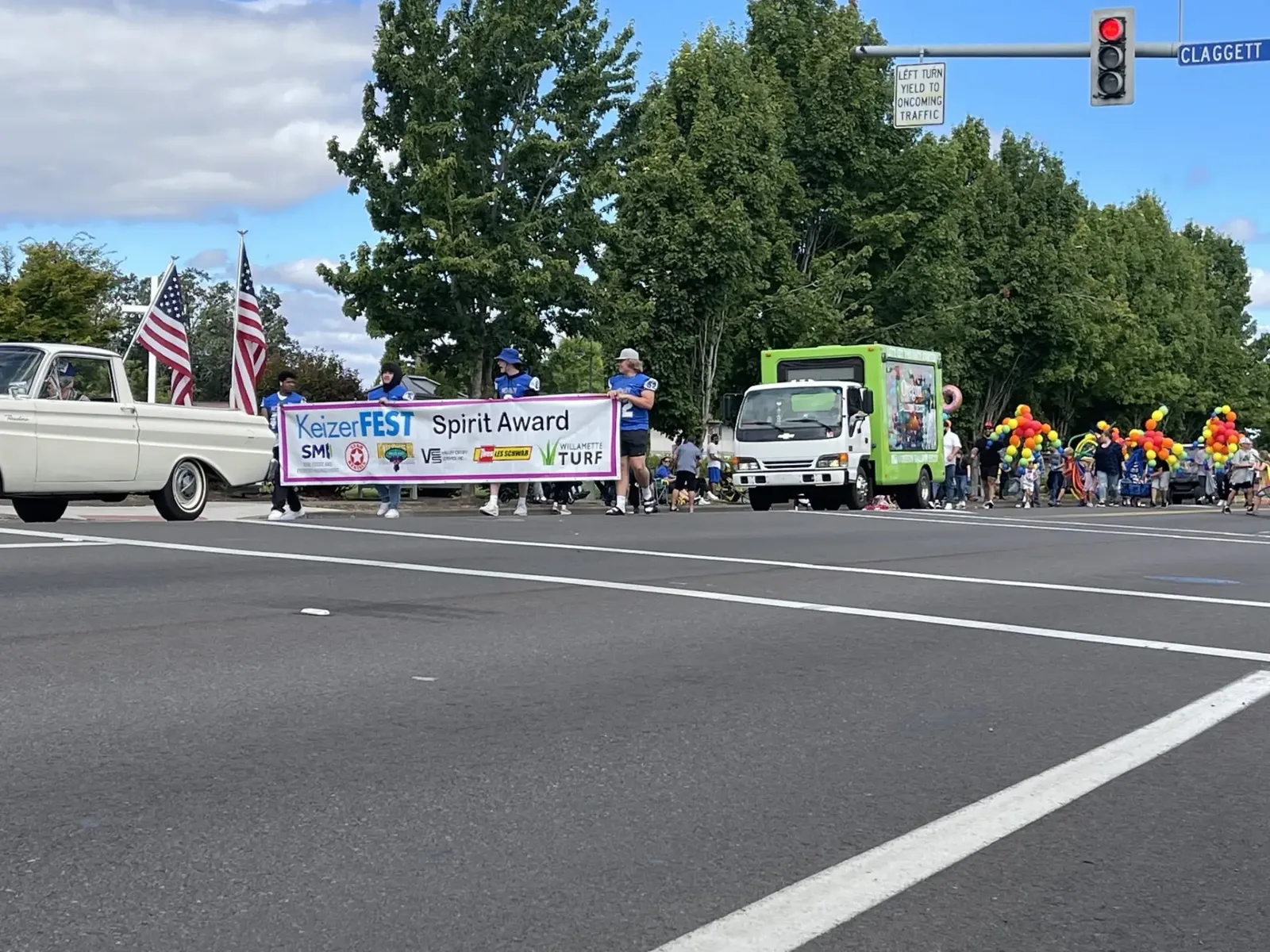 High school students carrying the KeizerFEST Spirit Award banner during the parade