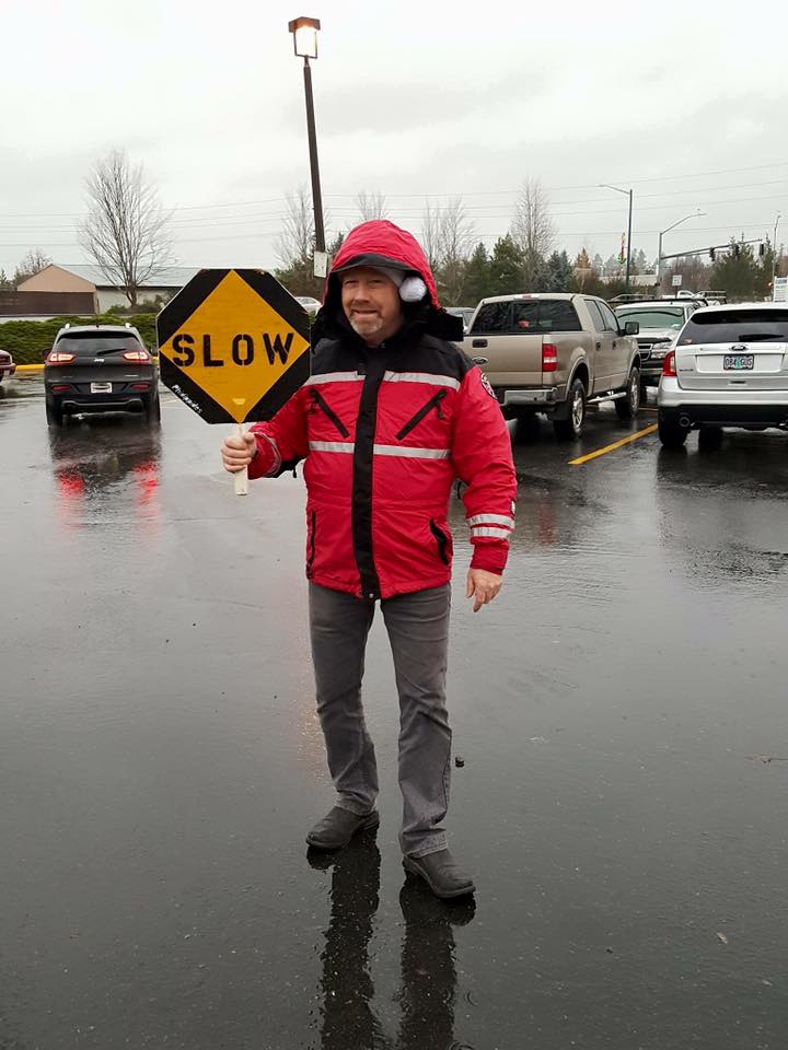 Traffic control guy holding "Slow" sign